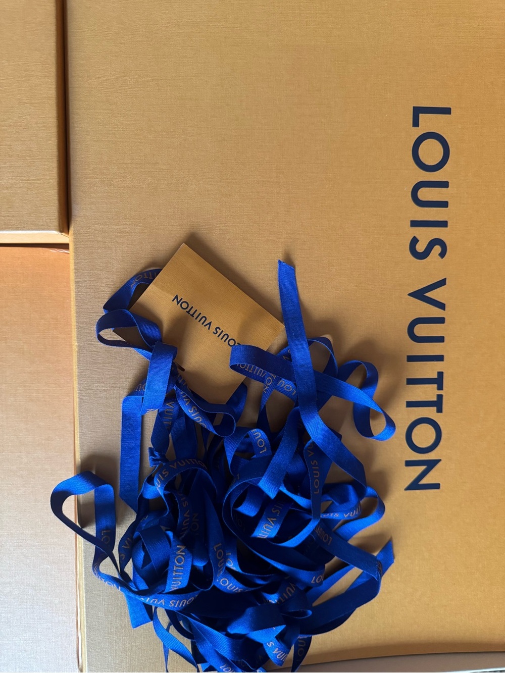 Louis Vuitton tan boxes with royal blue ribbons